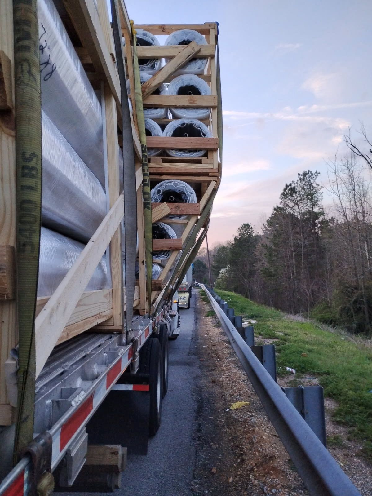 Workers re-securing a shifted load on a semi truck trailer — load transfers Chattanooga Ringgold
