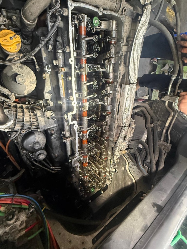 Semi truck engine repair — diesel mechanic working on heavy-duty engine, valve cover off, Ringgold GA